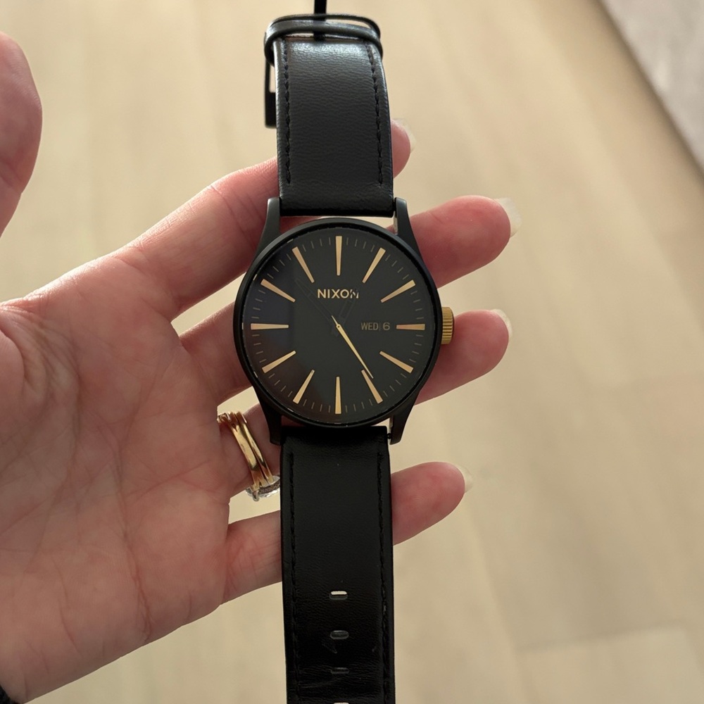 Nixon Black and Gold Timepiece
